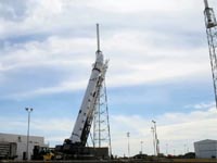 Falcon 9 vehicle being raised from horizontal position